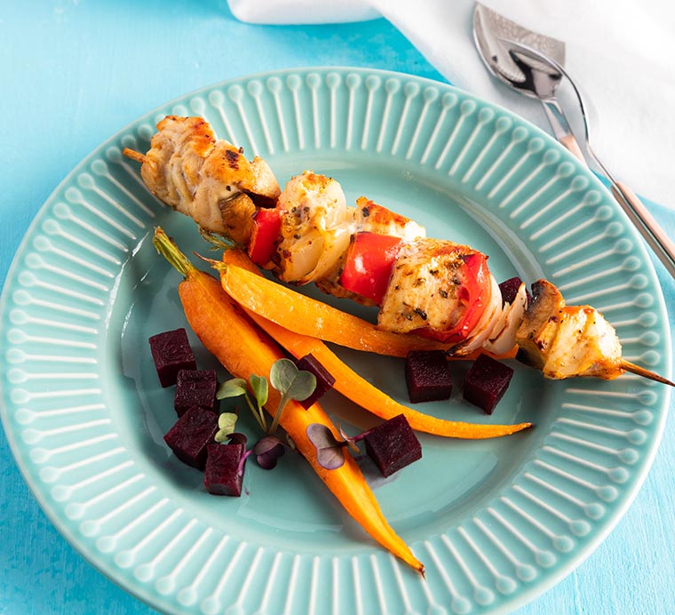 Baked chicken breast kabobs and baked vegetables - carrots and beetroot
